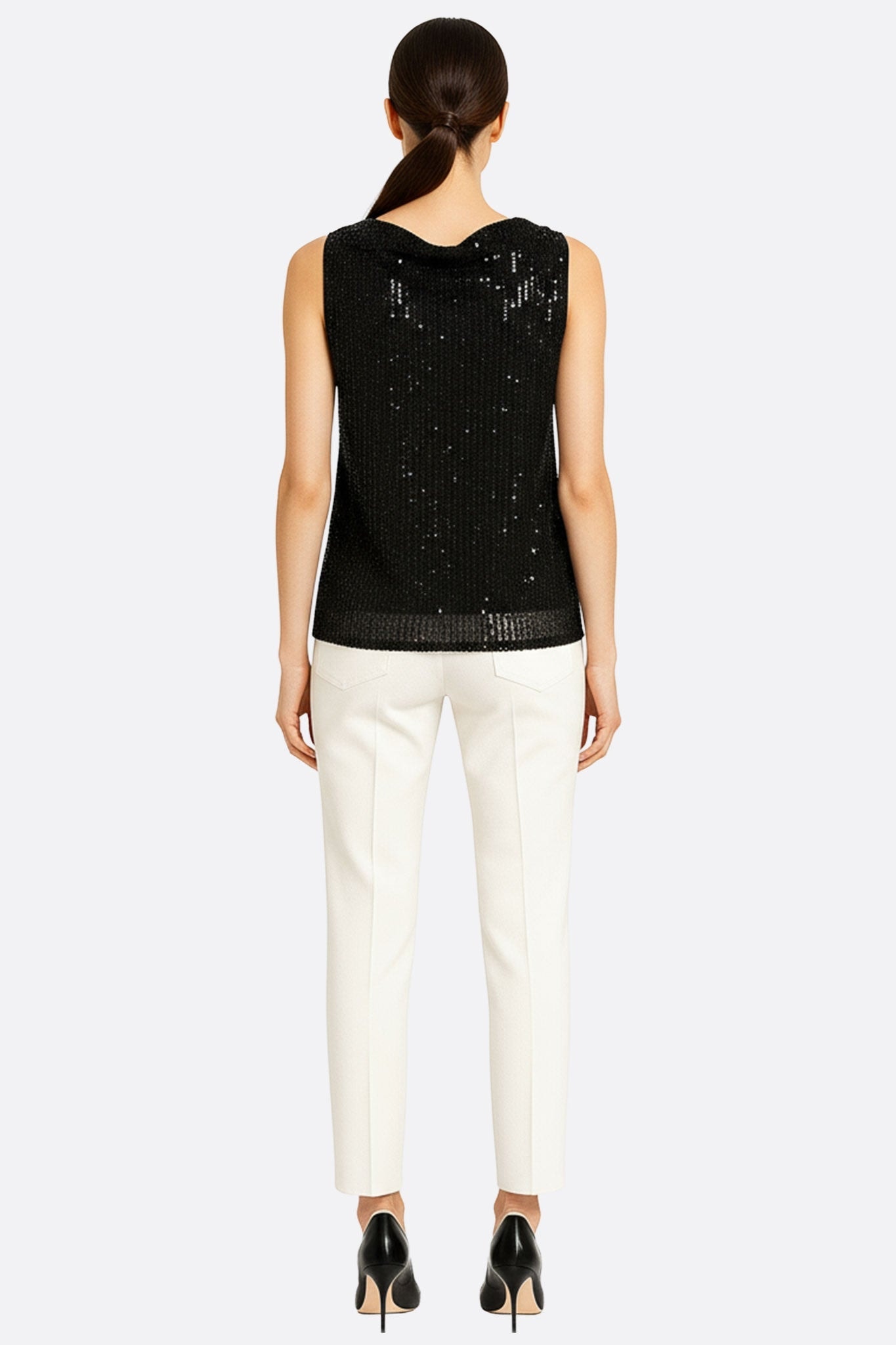Detail of a black sequined top, highlighting the luminous texture and modern cut for a sophisticated outfit
