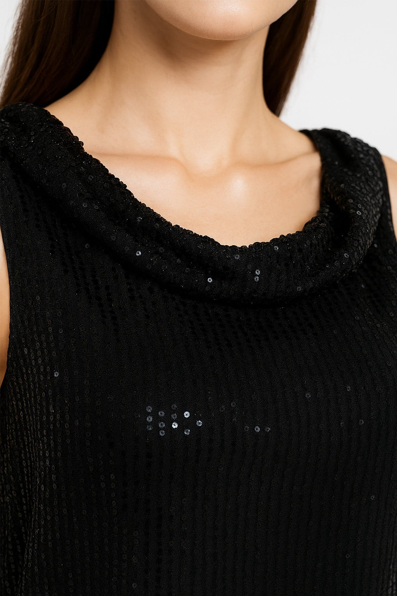 Detail of the chic sleeveless black top, enhanced with sparkling sequins, perfect to brighten your elegant evenings