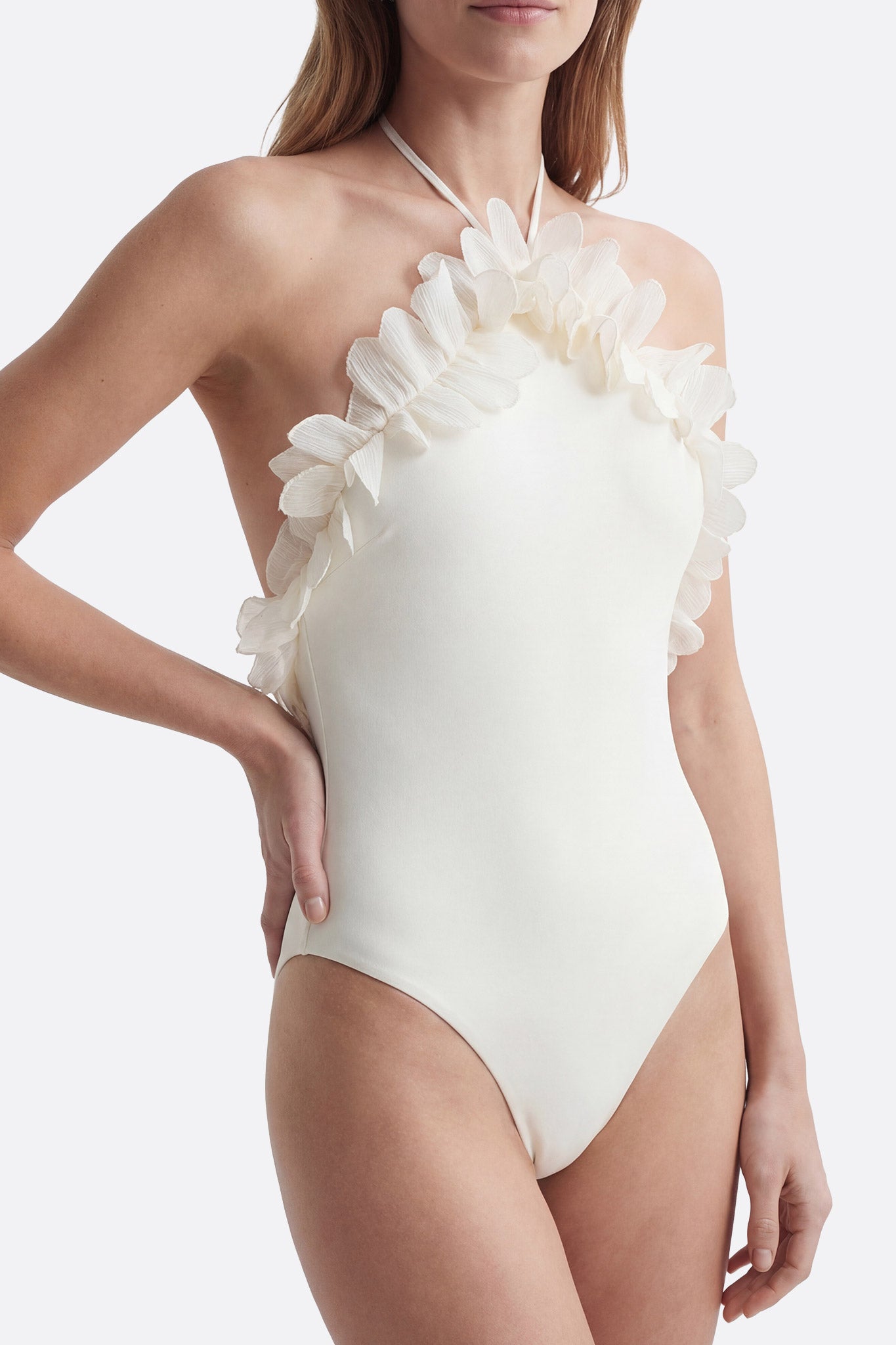 Flattering ivory one-piece swimsuit embellished with textured ruffles, ideal for a stylish and chic beach look.
