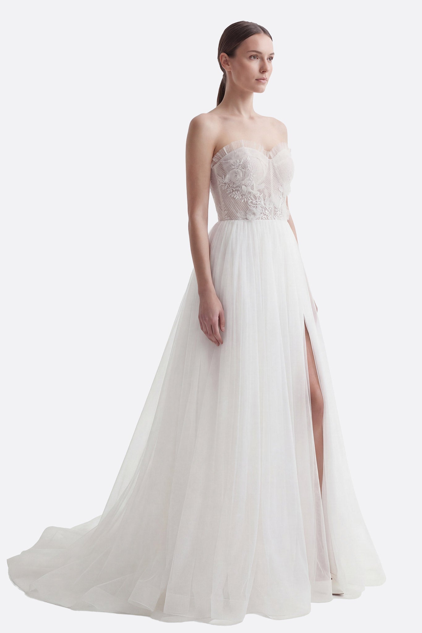 Romantic strapless tulle wedding dress with detailed embroidered corset, thigh-high slit, and an elegant removable cape...