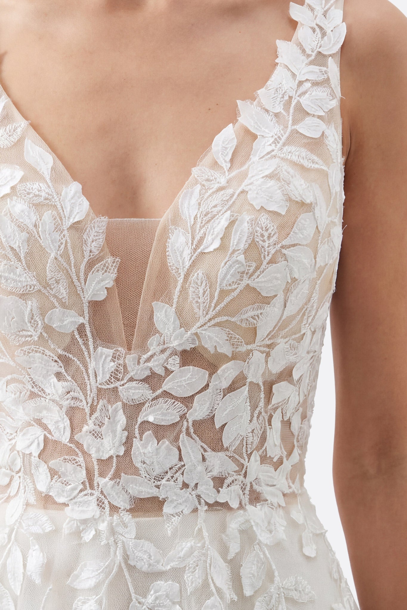 
Vue alternative de la robe de mariée en tulle avec dentelle, mettant en valeur le décolleté en V et l'effet aérien.



