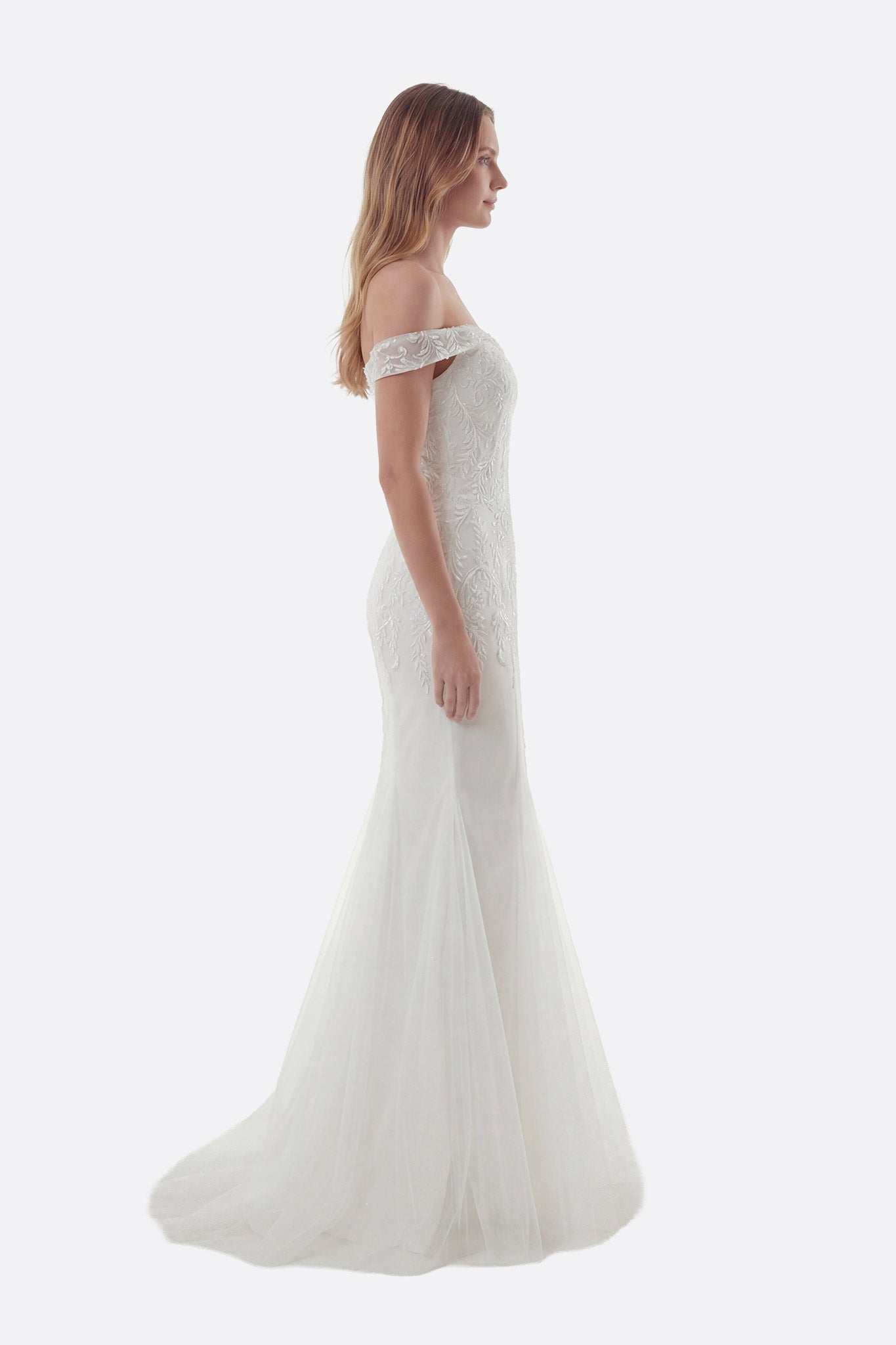 Strapless mermaid wedding dress with a fitted bodice and flowing removable train, exuding modern elegance and sophistication.