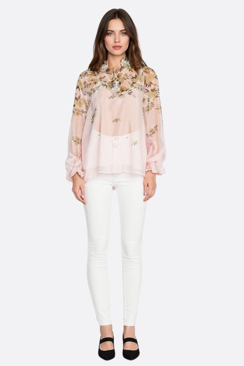
Zoom sur les motifs floraux d'une blouse en voile rose pastel, délicate et légère, idéale pour des occasions printanières...



