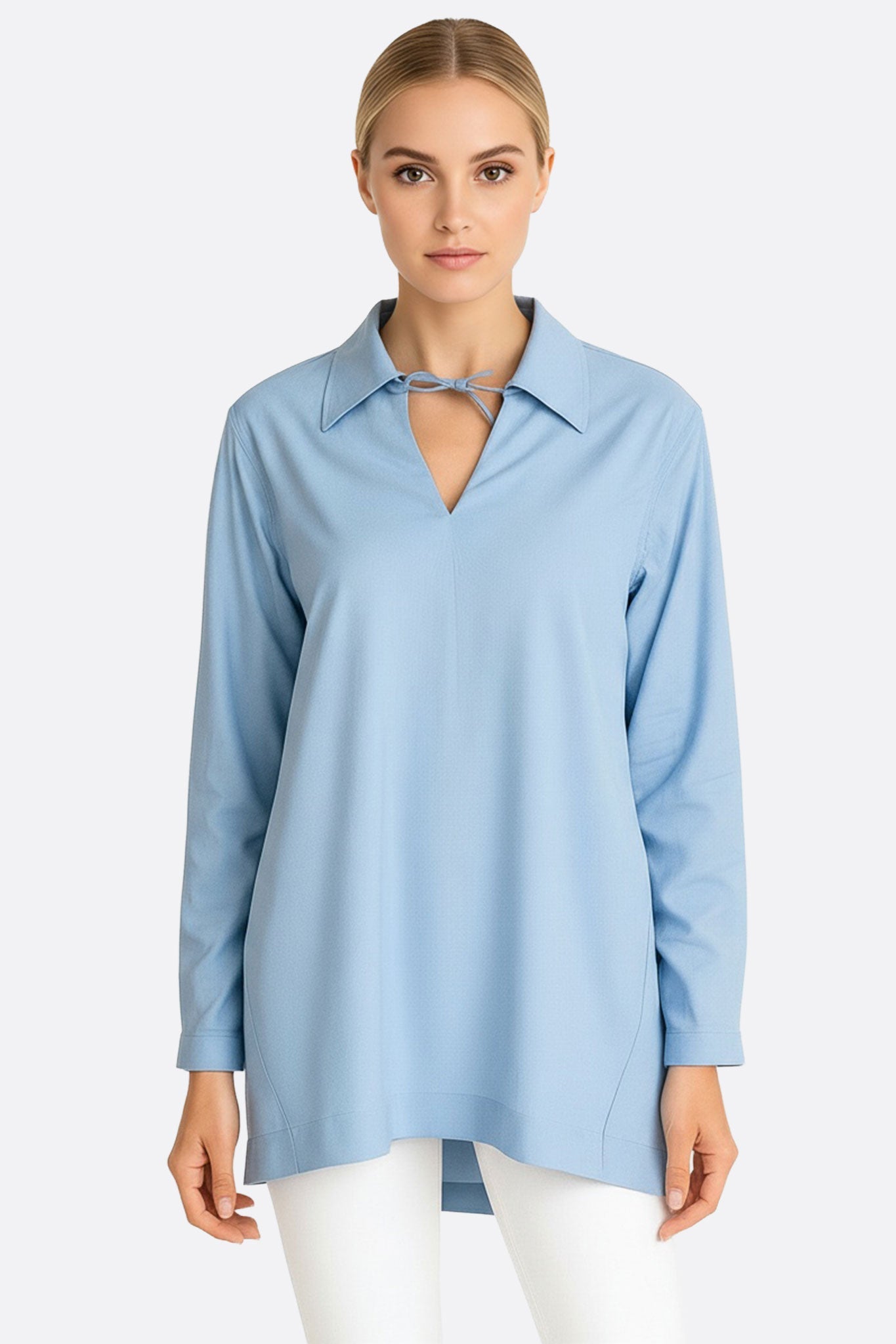 Light blue tunic shirt made of breathable cotton with long sleeves, perfect for adding elegance to casual or evening outfits.