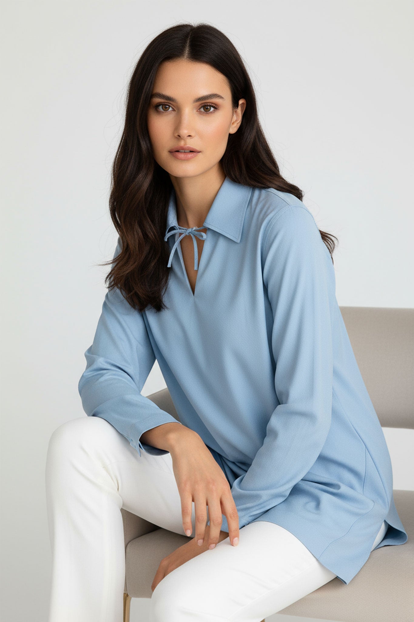 Refined detail of the light blue tunic shirt in premium cotton, showcasing the soft texture and impeccable craftsmanship.