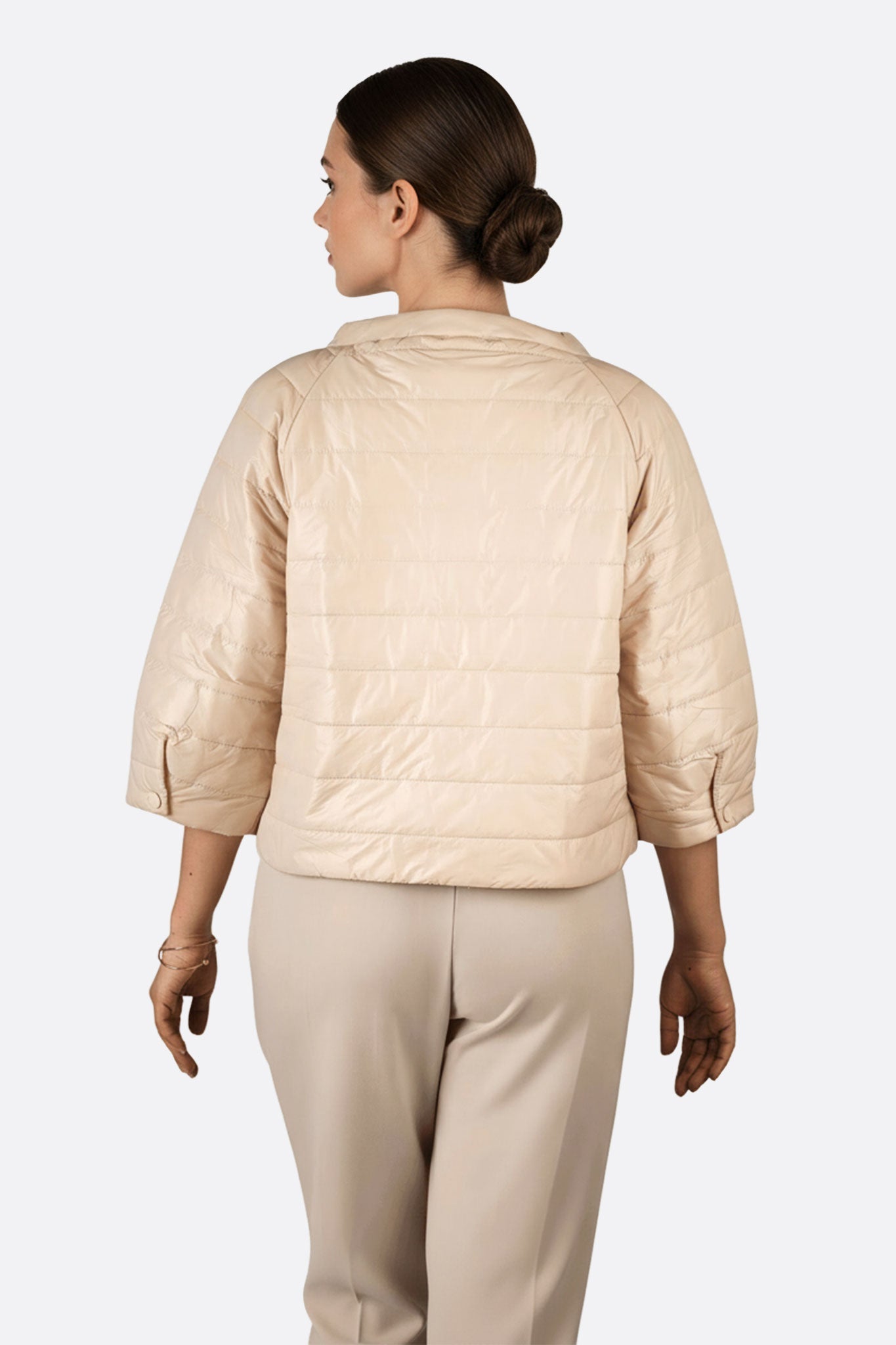 Stylish 3/4 sleeve lightweight beige puffer jacket, offering a fresh perspective for elegant layering during chilly days.