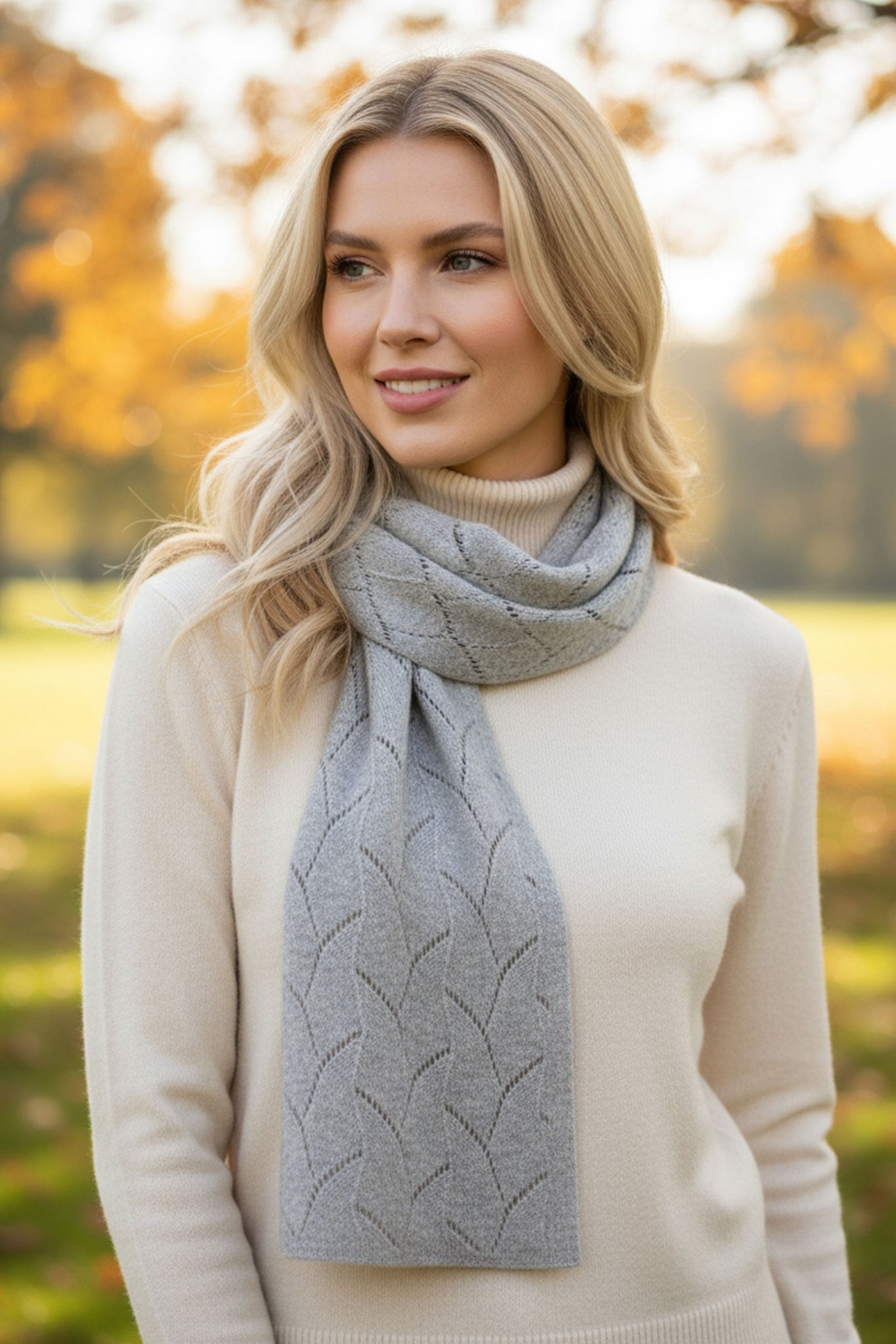 Chic grey cashmere scarf featuring delicate open-knit texture, adding a refined touch to your daily ensembles for any...