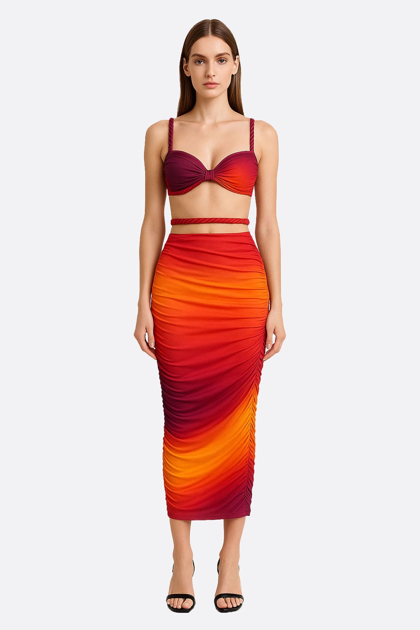 Conjunto de playa de dos piezas con falda larga asimétrica y top bustier de tirantes trenzados en degradado rojo y naranja.