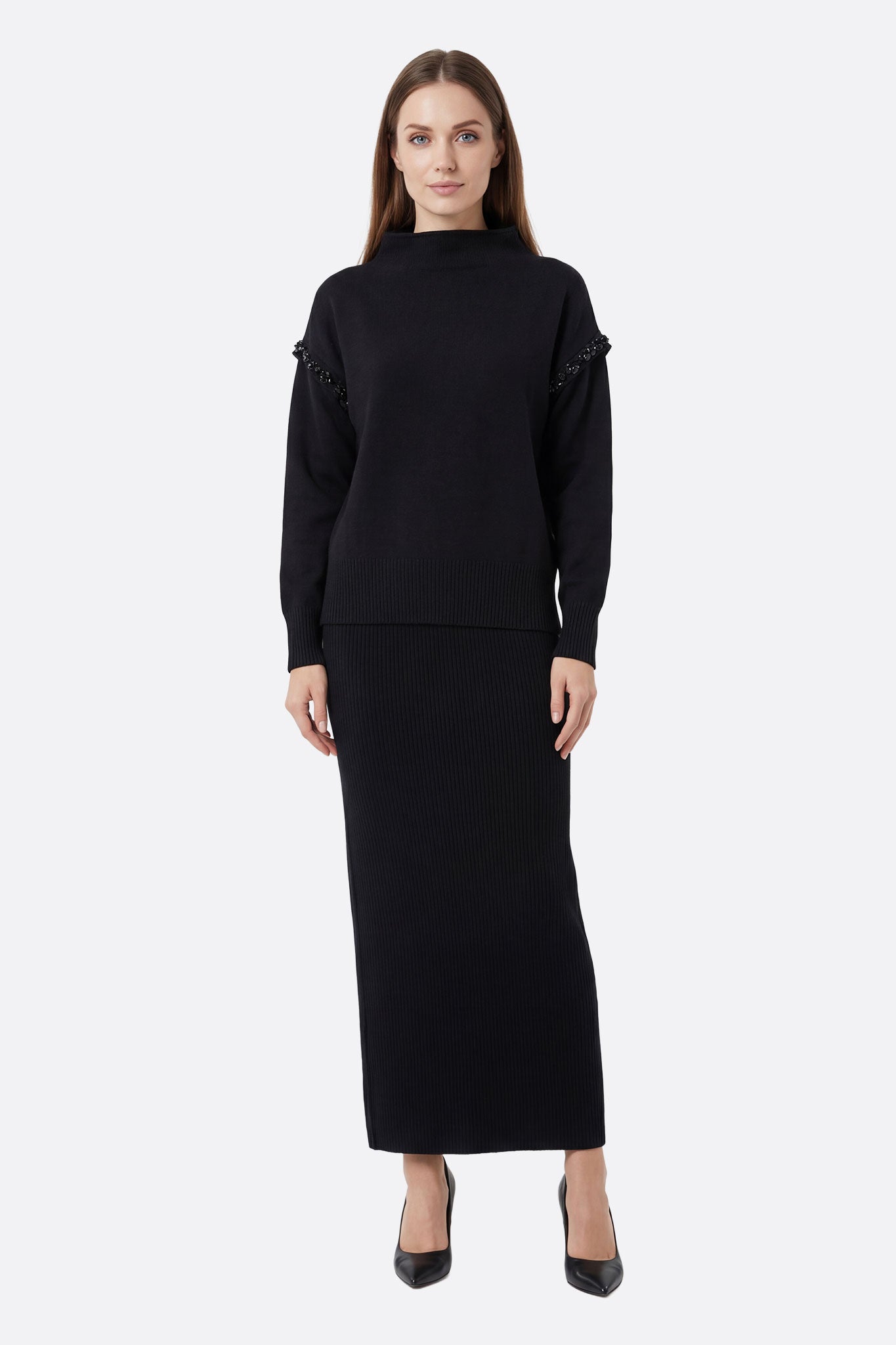 Ensemble chic jupe longue en tissu léger et pull noir en maille délicate, parfait pour une sortie élégante en soirée.