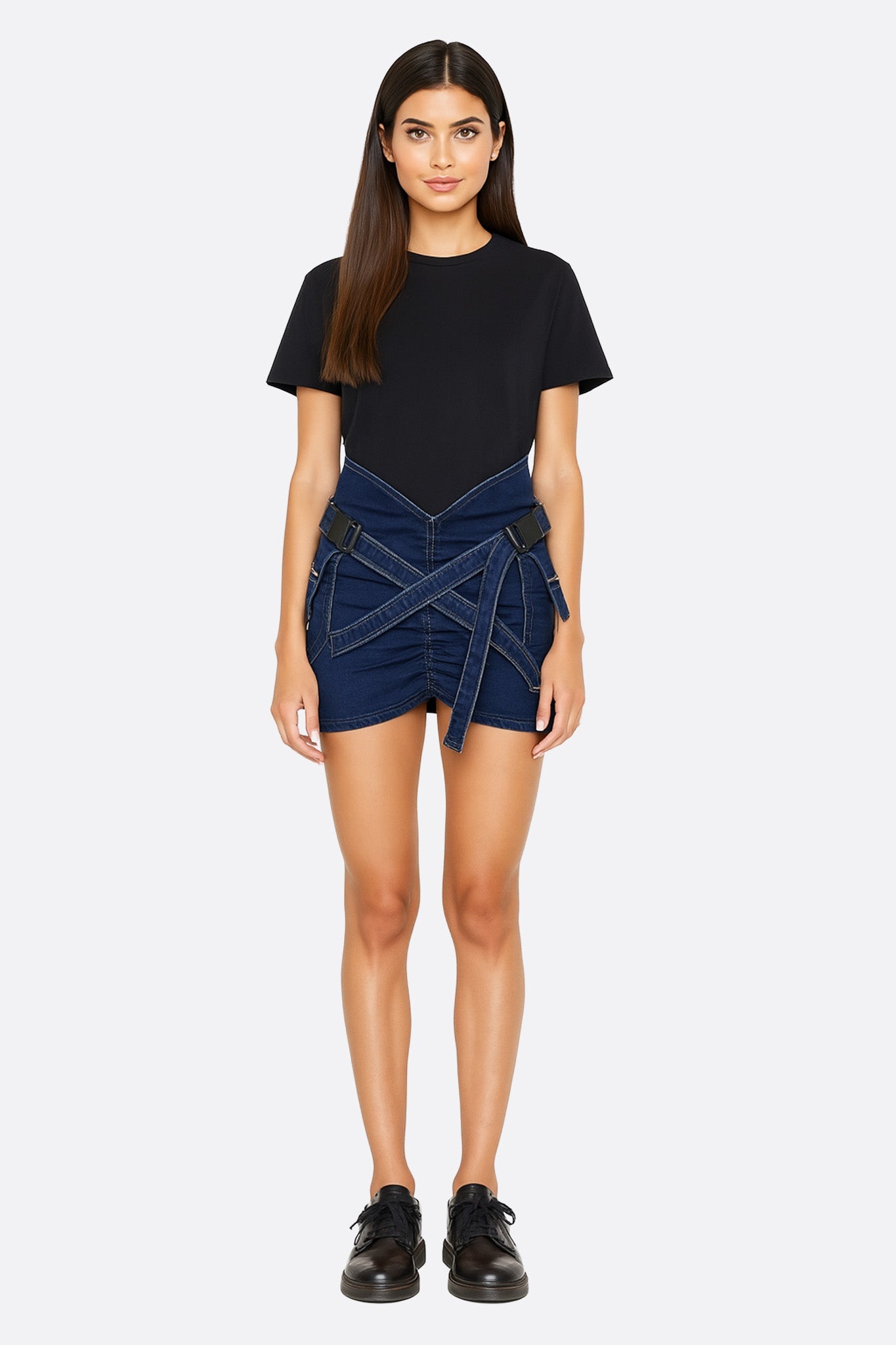 Stylish crisscross strap denim skort in structured fabric, ideal for a modern look at brunch or evening events.