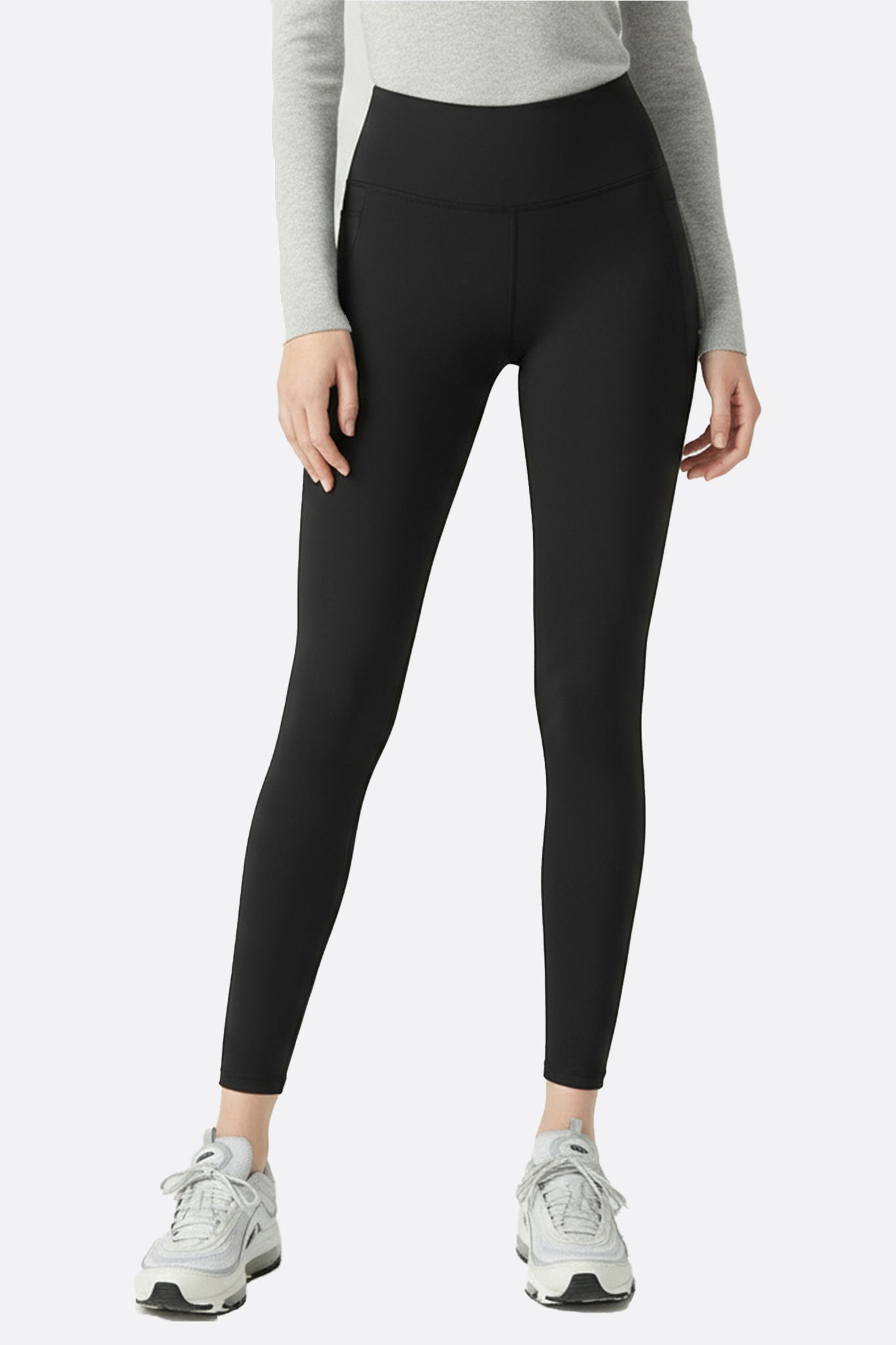 Legging noir taille haute en matière technique, parfait pour un look raffiné et actif lors de vos activités quotidiennes.