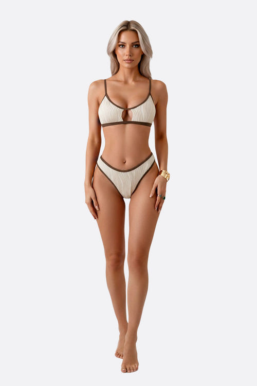 
Maillot de bain deux-pièces en beige, liseré marron, avec une texture ondulée, idéal pour des vacances élégantes au bord...



