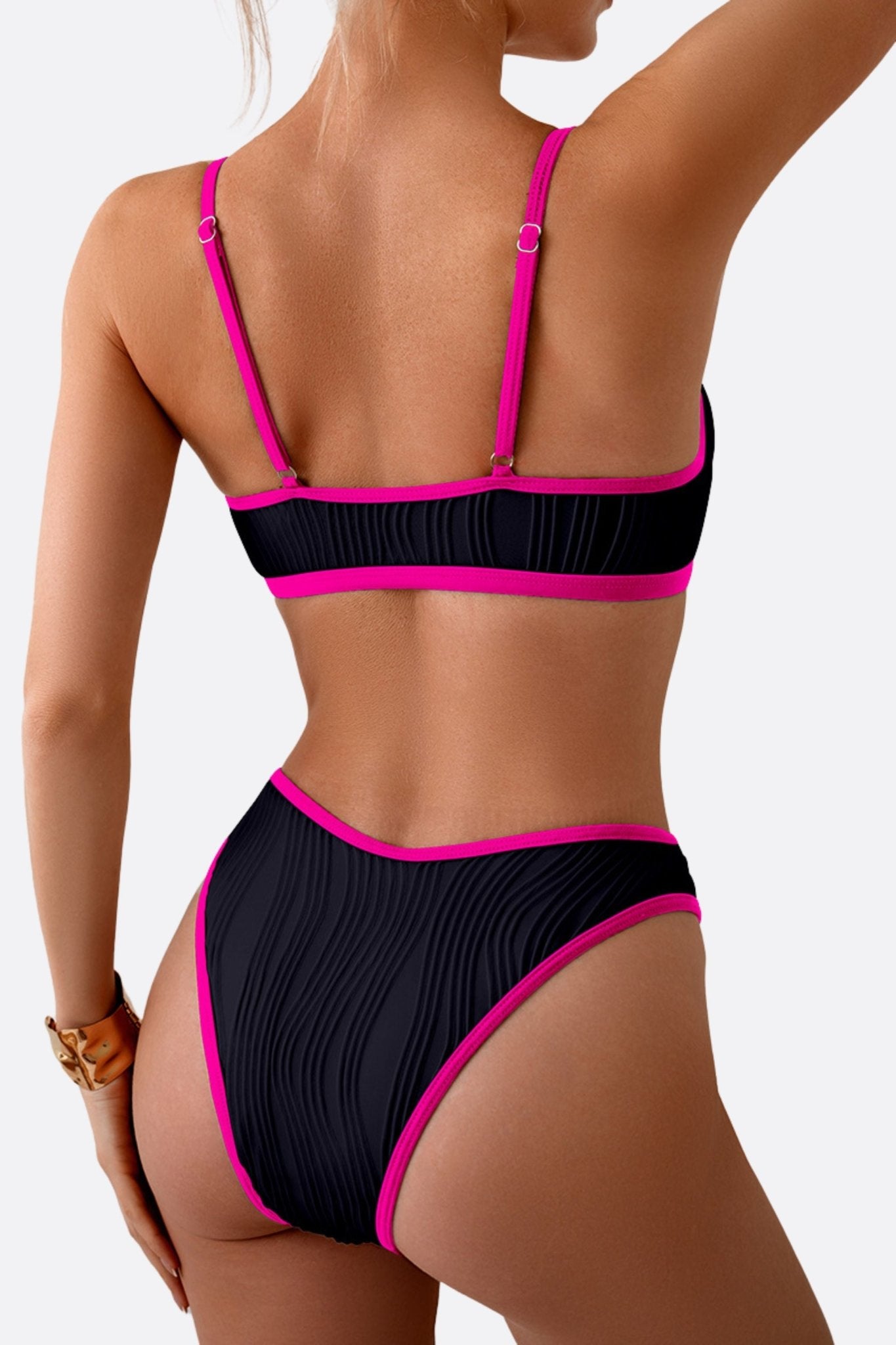 
Vue alternative du bikini noir à liseré rose, soulignant la délicatesse des bretelles et la silhouette moderne et audacieuse.



