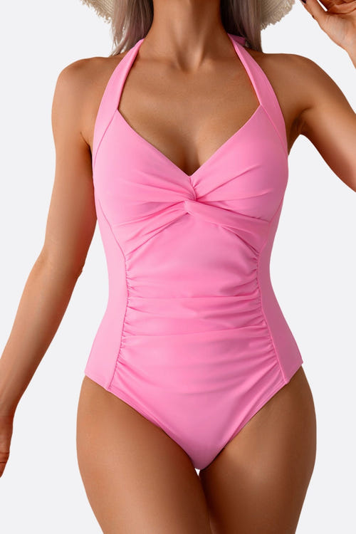 
Détail élégant du maillot de bain une pièce rose pâle, noué à l'avant pour une silhouette féminine raffinée.



