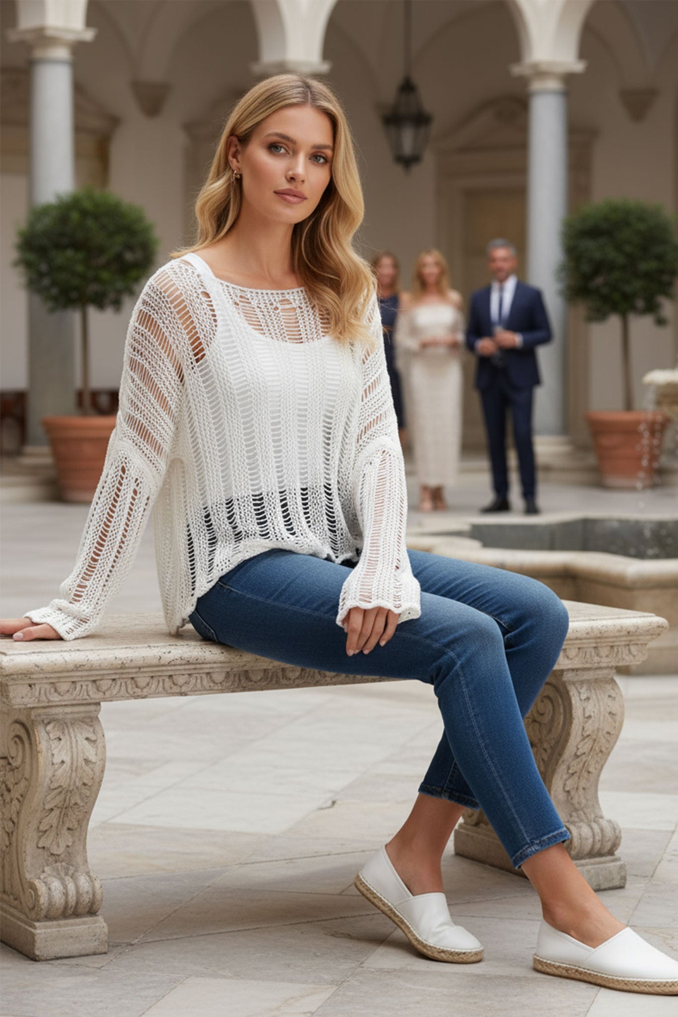 Back detail of an elegant white open-knit pullover, emphasizing its lightweight texture and perfect for warm weather styling.