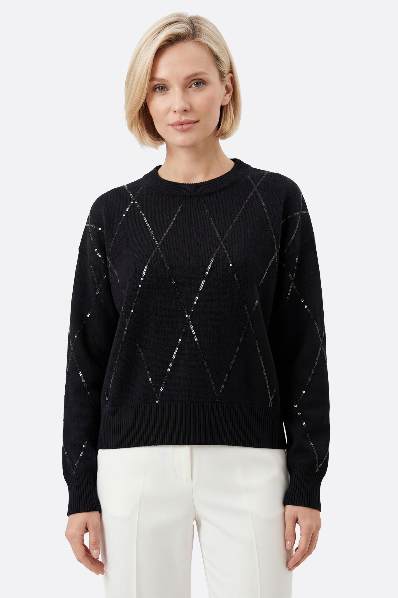 Suéter negro de lana con detalles brillantes, ideal para un look elegante y versátil en cualquier ocasión.