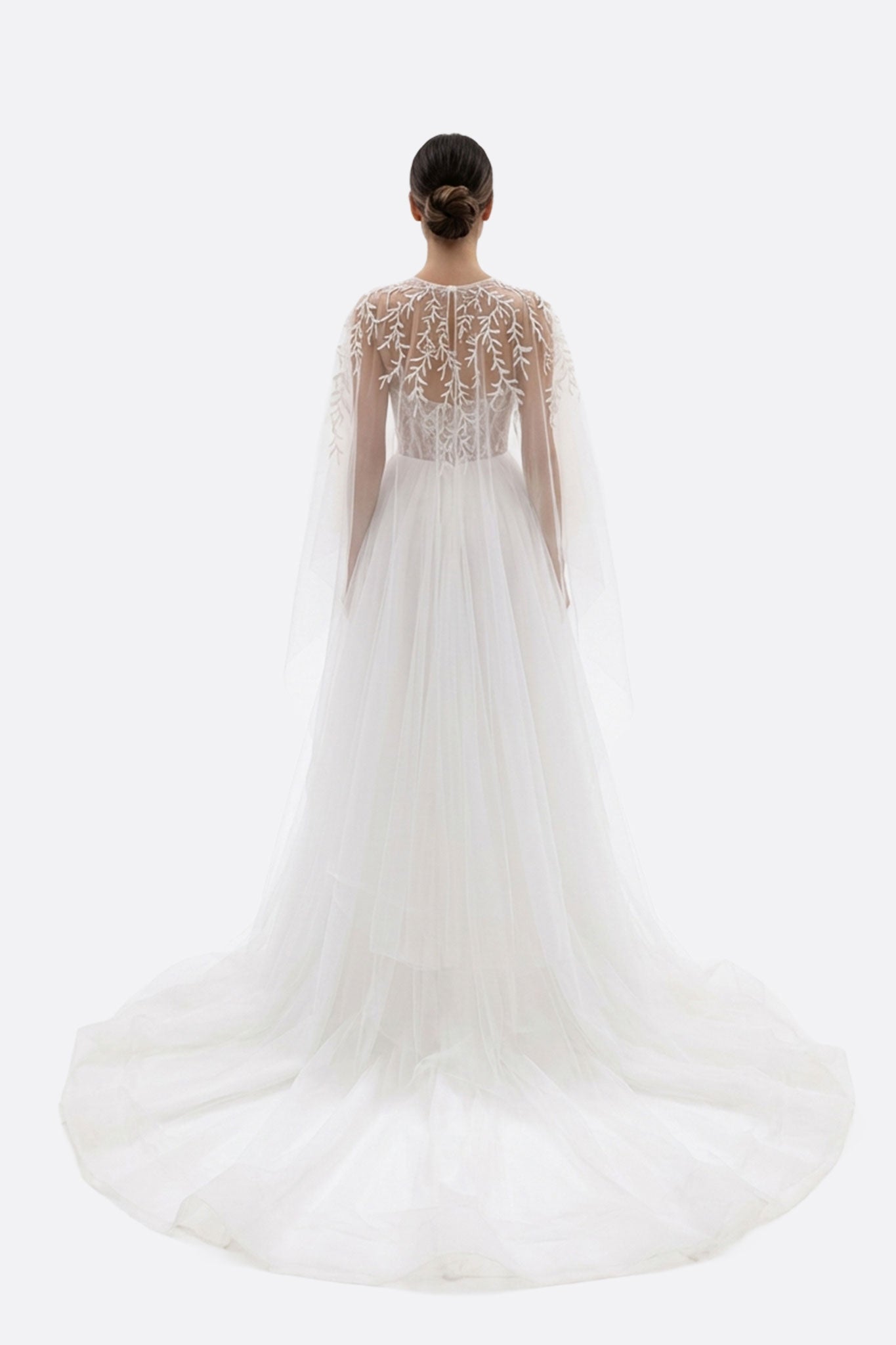 Robe de mariée Alena en tulle blanc, mettant en évidence le bustier et la surcape pour un look romantique et raffiné.
