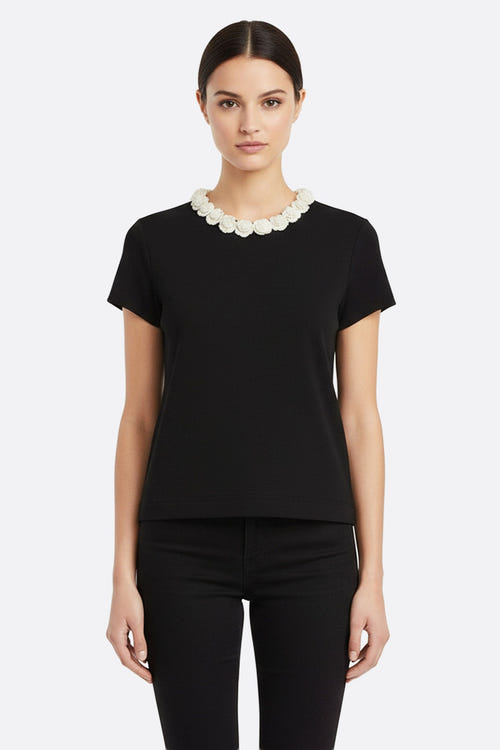 
T-shirt noir à col camélias perlés, mettant en valeur une silhouette élégante, idéal pour un look chic au quotidien.



