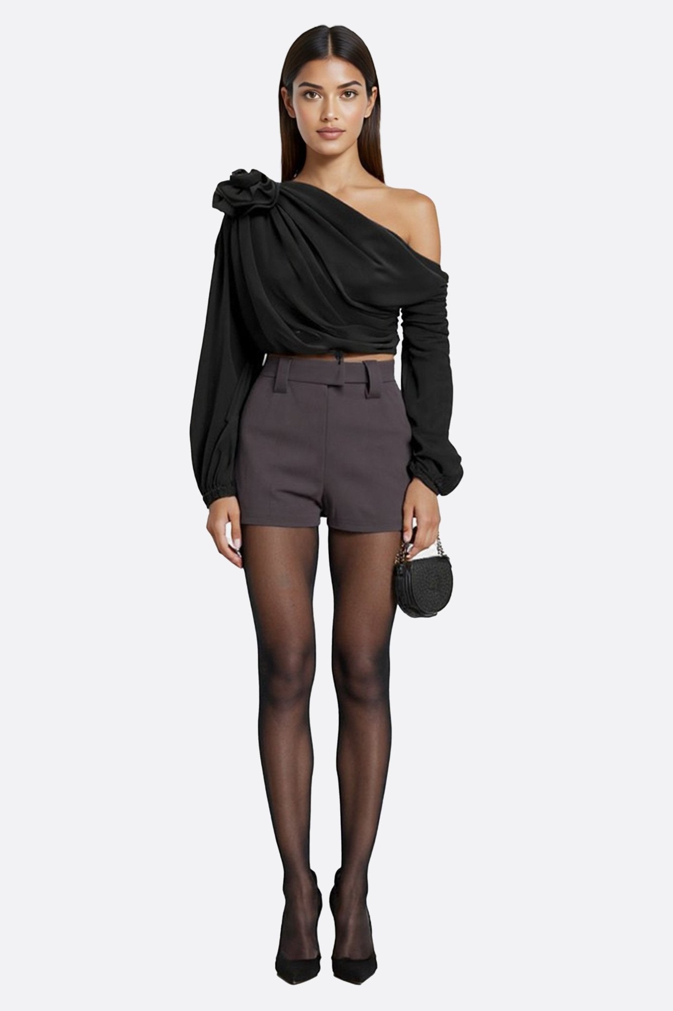 Sculpted floral detail accentuates the draped black asymmetrical top, ideal for chic soirées or refined daytime outings.