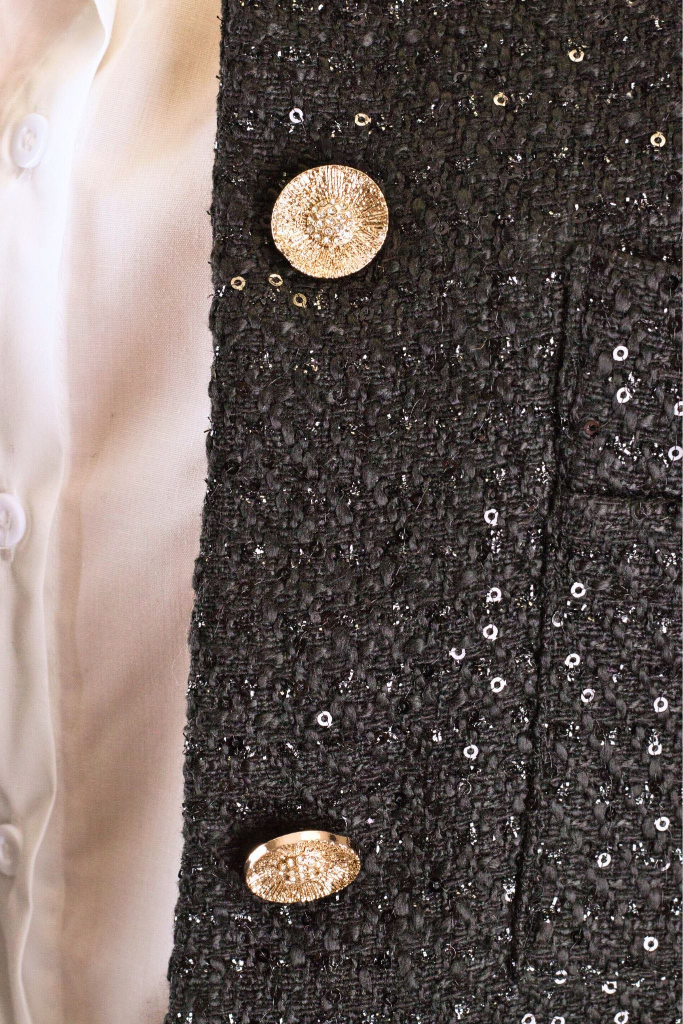 Короткий жакет из черного твида с блестящими пайетками, вид сбоку, стильный выбор для вечернего наряда.