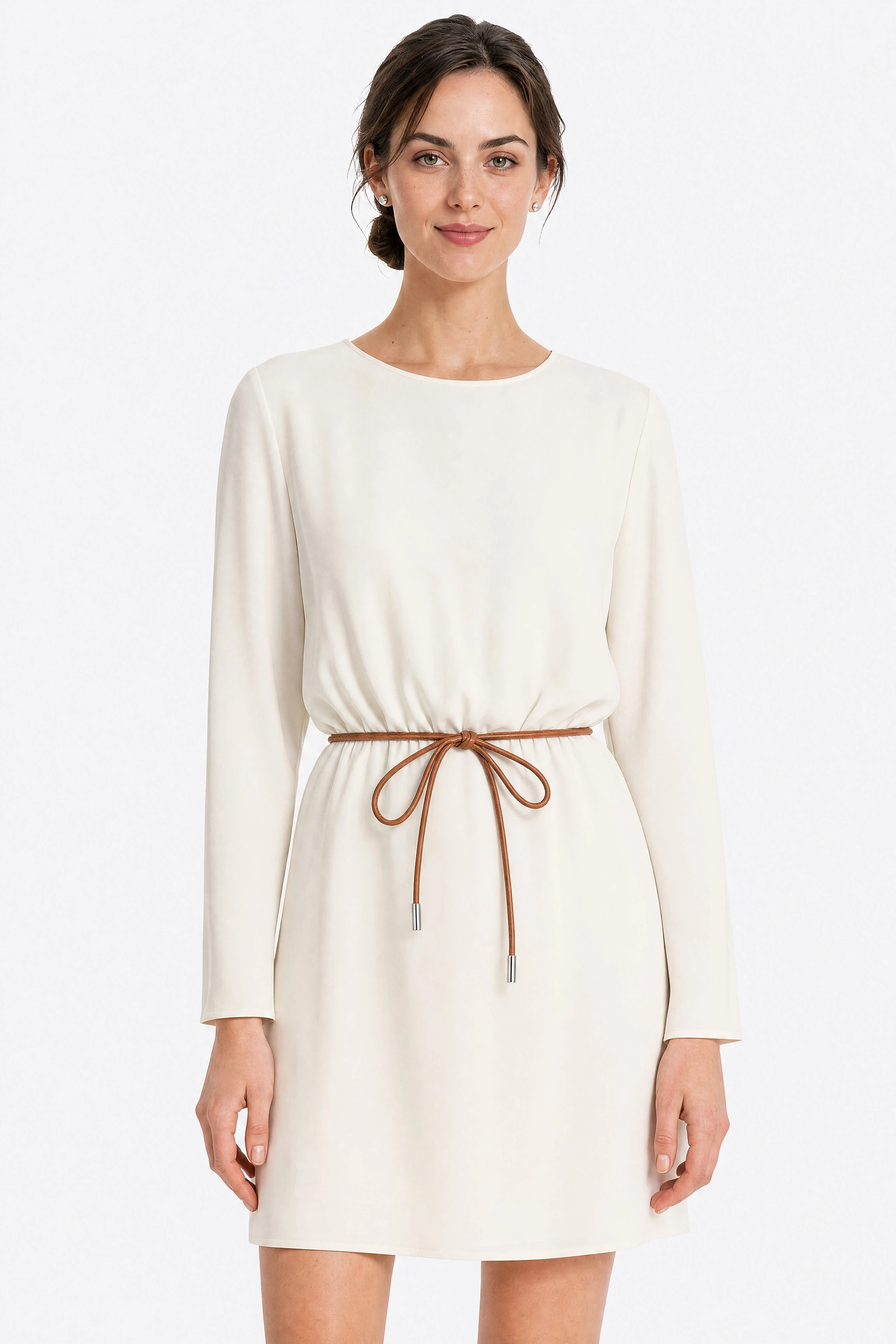 Brown cord belt tied in a bow at the waist of an ivory dress, front view