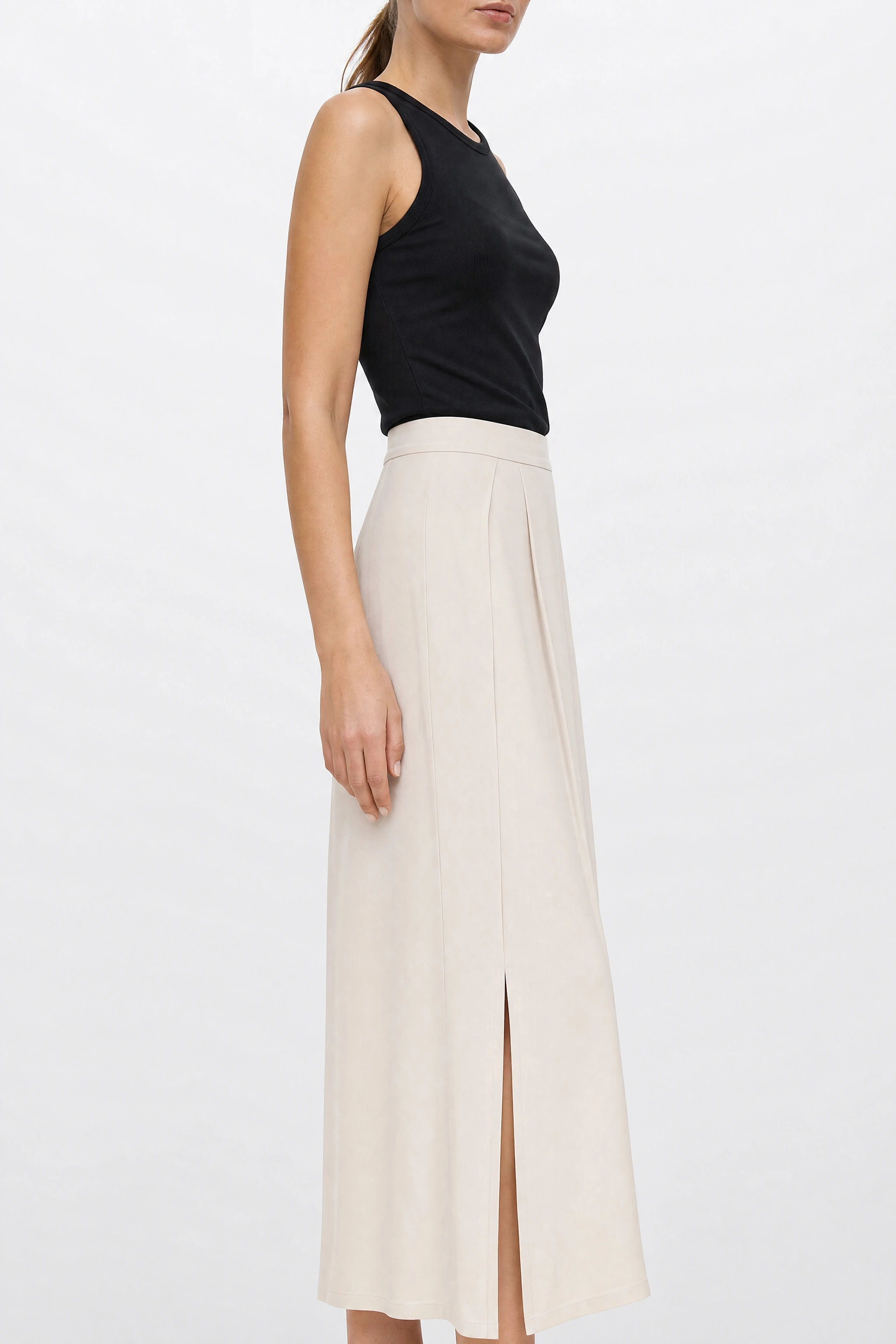 Close-up of the flat waist and hip yoke of the long ivory skirt