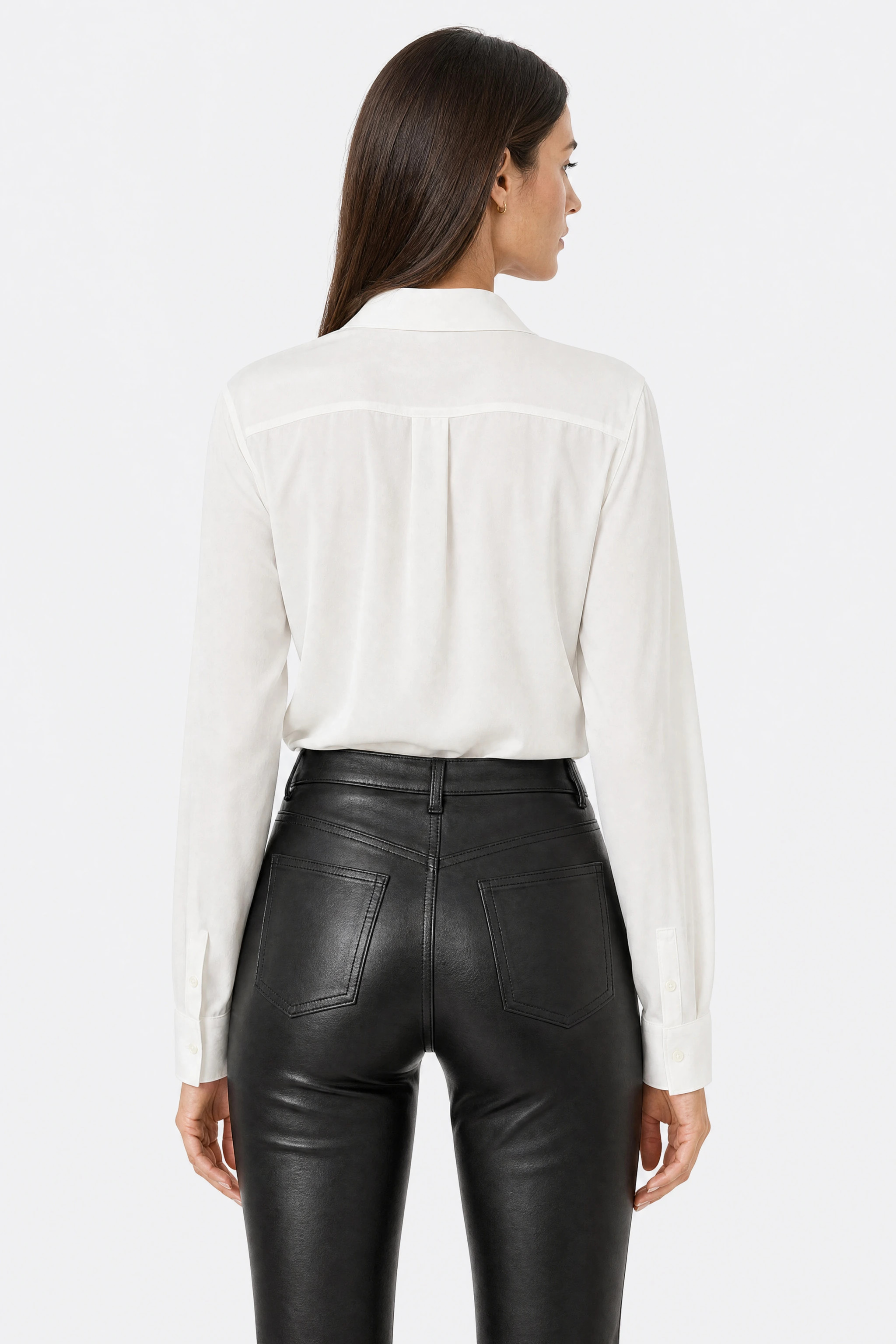 Black faux leather trousers, close-up of the back yoke and patch pockets, with the sheen of the faux leather