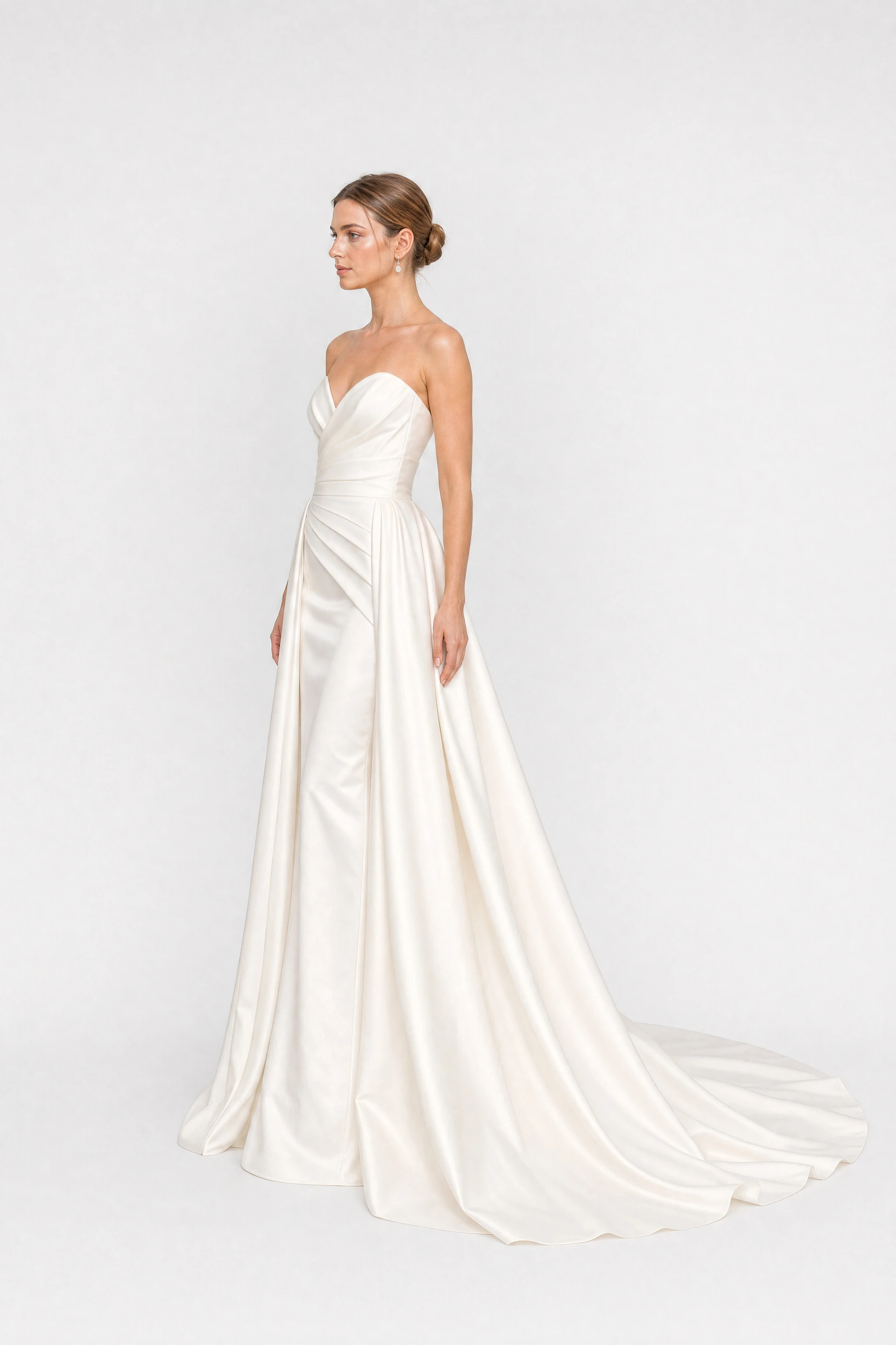 Long white satin strapless wedding dress with a train, side view
