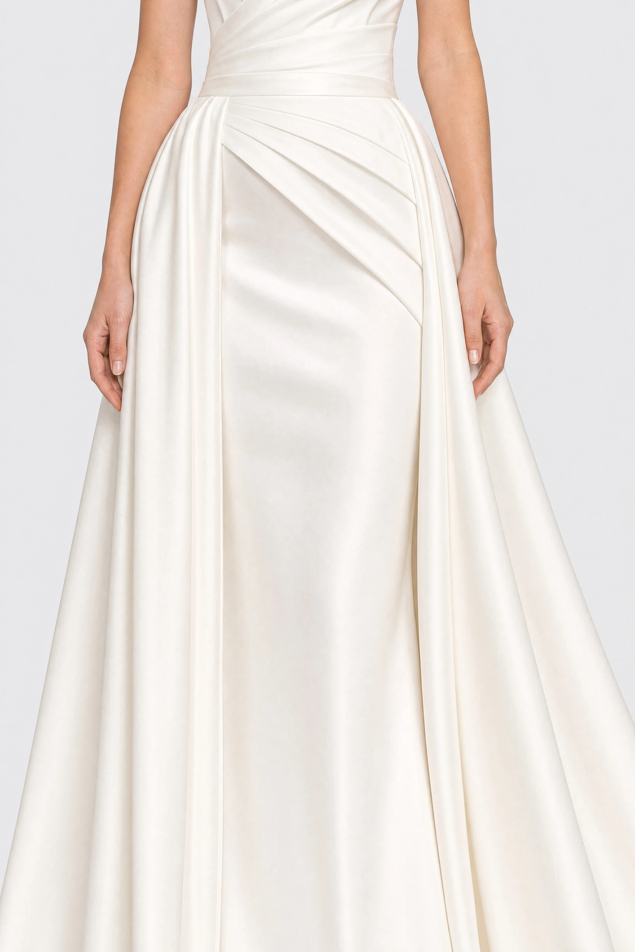 Long white satin strapless wedding dress with a train, close-up of the open overskirt over the satin column skirt